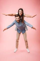 Wall Mural - Full length portrait of a cheerful young man