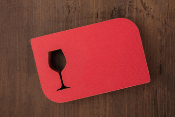Wall Mural - Overhead photo of laser cut red business cards with wineglass