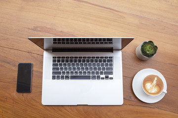 Aufkleber - Modern laptop with cup of coffee and mobile phone on wooden table