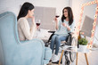 © zinkevych - Friendly atmosphere. Adorable handicapped woman and friend drinking wine and gossiping