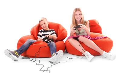 Wall Mural - Cute children playing video game on white background