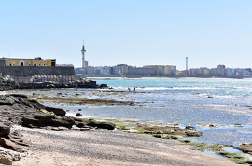 Cadiz seafront with a view of the Telefonica tower and fishing people, Cadiz Andalusia Spain Europe