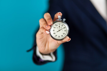 Female hand holding a stopwatch