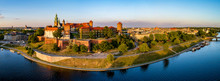 Krakow, Poland. Wide Aerial Panorama At Sunset With Royal Wawel Castle And Cathedral. Far View Of  Old City And Old Jewish Kazimierz District. Vistula River Bank, Park, Promenade And Walking People
