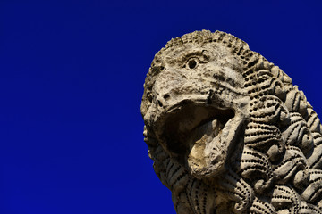 Canvas Print - Ancient medieval lion statue, in the the Lucca old walls public park (with copy space)