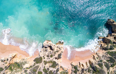 Wall Mural - Aerial view of sandy beach and ocean with beautiful clear turquoise water.