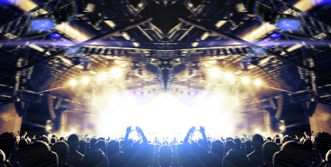 Live event stage lit with people attending the concert