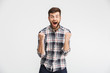 © Drobot Dean - Portrait of an excited young man in plaid shirt
