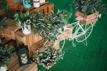 Wood Hand Made Welcome Wedding Decoration With Vase Flower And Small Bicycle On Green Wall.