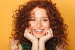 © Drobot Dean - Close up portrait of a smiling curly redhead woman