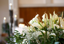 Flowers On An Altar In The Church And The Candles On Background