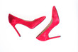 Luxury footwear concept. Footwear with thin high heels, stiletto shoes, top view. Shoes made out of red suede on white background, isolated. Pair of fashionable high heeled pump shoes.