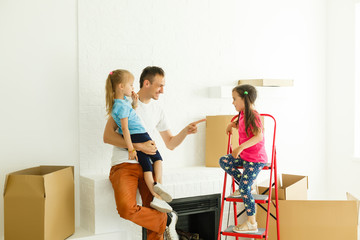 Wall Mural - Happy family father and child daughter making repairs, fireplace; boxes