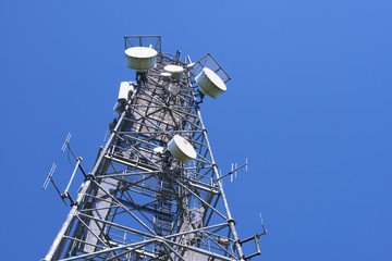  Telecommunication tower with antennas against the blue sky
