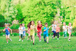 © davit85 - Many different kids, boys and girls running in the park on sunny summer day in casual clothes