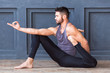 © uv_group - Young man practicing yoga asana and meditation on urban grunge background.