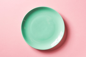 green plate on pink background, from above