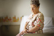 © Erickson Stock - Sad old lady sitting indoors