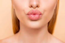 Air Kiss For You. Close Up Cropped Shot Of Femenine Gorgeous Charming Adorable Lady With Nude Natural Full Big Pout Lips Isolated On Beige Background, Perfection Wellness Wellbeing Concept