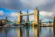 © zgphotography - London, England - Iconic Tower Bridge at sunrise with sightseeing boat and red double-decker bus on it and Shard skyscraper at background