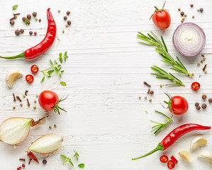 various herbs and spices on white wooden table