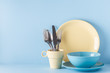 © tbralnina - Crockery and cutlery on a blue pastel background