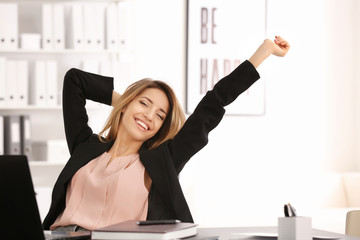 Poster - Beautiful businesswoman relaxing in office