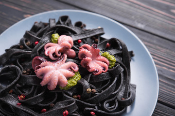 Wall Mural - Italian black pasta with cuttlefish ink and marinated octopus