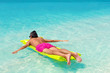 © photopixel - Man with inflatable green mattress on beach