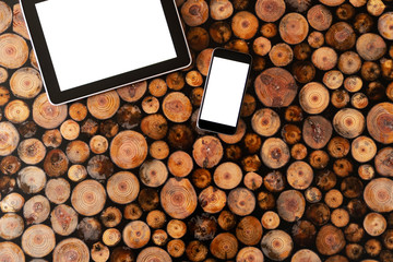 Wall Mural - Digital tablet pc and mobile phone on wood background.Felled wood. Wood texture