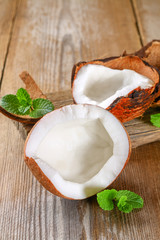 Wall Mural - Coconut with mint on old wooden table. Organic healthy food concept.Beauty and SPA concept.