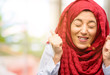 © Krakenimages.com - Young arab woman wearing hijab happy and surprised cheering expressing wow gesture