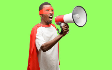african black super hero man communicates shouting loud holding a megaphone, expressing success and 
