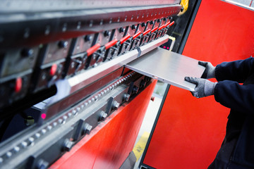 man working with cnc break press machine