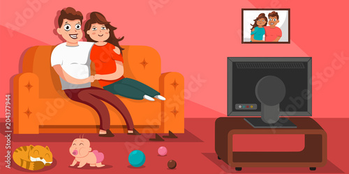 Happy Family Watching Tv Sitting On The Sofa In Living Room