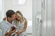© Erickson Stock - Smiling new parents proudly looking down at their newborn baby daughter.