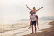 © Mediteraneo - Happy couple in love on beach summer vacations. Joyful girl piggybacking on young boyfriend having fun.