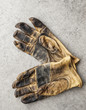 © Mint Images - Close-up of a pair of used work gloves in a shop