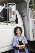 © Mint Images - Female truck driver with her delivery truck