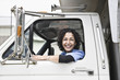 © Mint Images - Female truck driver with her delivery truck