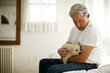 © Erickson Stock - Man holding a puppy.