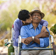 © Erickson Stock - Senior woman kissing her husband with nasal tubes.