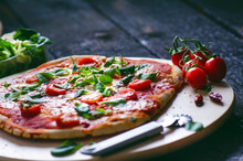 Italian Food, Cuisine. Margherita Pizza On A Black, Wooden Table With Igredients Like Tomatoes, Salad, Cheese, Mozzarella, Basil. Delicious Homemade Food. 