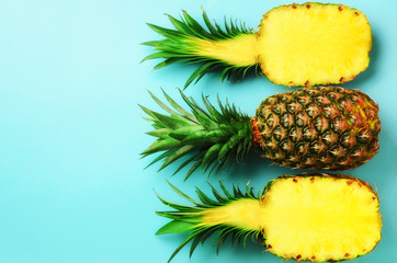 Wall Mural - pattern with bright pineapples on blue background. top view. copy space. minimal style. pop art desi
