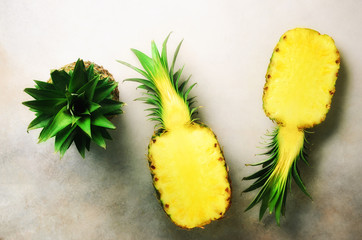 Wall Mural - fresh half sliced pineapple on gray background. top view. copy space. bright pineapples pattern for 