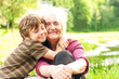 © alonaphoto - Happy grandmother with grandson together. Grandson hugs his beloved grandmother