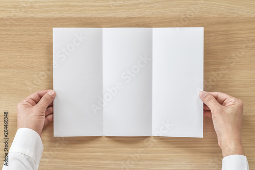 Fotografía Trifold pamphelt mock up flyer brochure design A4 size paper in business man's h
