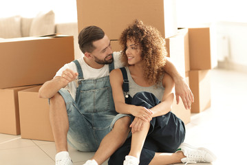 Wall Mural - smiling couple on the background of large cardboard boxes.