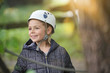 © goodluz - Portrait of smiling little girl wearing helmet at rope park