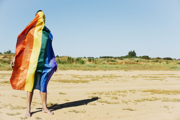 Sticker - man covered with a rainbow flag